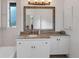 Light and bright bathroom features framed mirror, ceramic tile, and a large window for natural light at 6612 Saint James Xing, University Park, FL 34201