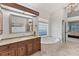 Bathroom features a jetted tub under a window, a tile floor, framed mirrors, and granite countertops at 6612 Saint James Xing, University Park, FL 34201