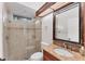 Modern bathroom features granite countertop, glass shower, ceramic tile, framed mirror and updated fixtures at 6612 Saint James Xing, University Park, FL 34201