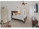 Bedroom with white walls, carpet flooring, ceiling fan, and natural light from the open door and window at 6612 Saint James Xing, University Park, FL 34201