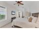 Bedroom with white walls, carpet flooring, ceiling fan, and natural light from the window with shutters at 6612 Saint James Xing, University Park, FL 34201