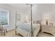 Bedroom with white walls, carpet flooring, canopy bed, shutters, and two dressers with lamps at 6612 Saint James Xing, University Park, FL 34201