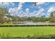 Picturesque croquet field on lush green lawn, offering a classic outdoor recreational activity by the lake at 6612 Saint James Xing, University Park, FL 34201