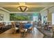 Spacious dining room featuring a tropical mural and unique light fixture at 6612 Saint James Xing, University Park, FL 34201