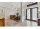 Elegant dining area featuring stone floors, designer lighting, and a view of the beautiful entryway at 6612 Saint James Xing, University Park, FL 34201