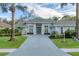 Stunning home showcasing a meticulous lawn, mature landscaping, and a grand paver driveway at 6612 Saint James Xing, University Park, FL 34201