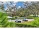 Scenic view of golf carts parked near a tranquil lake and lush greenery, ideal for leisurely rounds at 6612 Saint James Xing, University Park, FL 34201