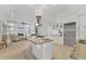 Open kitchen with a large island, stainless steel appliances, and seamless flow to the living area at 6612 Saint James Xing, University Park, FL 34201