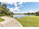 Picturesque walking path along the lake and golf course surrounded by lush greenery, and scenic views at 6612 Saint James Xing, University Park, FL 34201