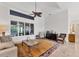 An inviting living room showcasing tile flooring, large windows, and natural light at 6612 Saint James Xing, University Park, FL 34201