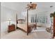 Serene main bedroom featuring a sitting area and a four-poster bed, offering a relaxing retreat at 6612 Saint James Xing, University Park, FL 34201