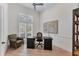 Bright office features a black desk, modern chair, hardwood floors, and natural light from the window with shutters at 6612 Saint James Xing, University Park, FL 34201