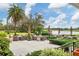Enjoy this outdoor patio featuring lake views, comfortable seating, umbrellas, and lush landscaping at 6612 Saint James Xing, University Park, FL 34201