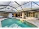 Inviting pool area with a spacious lanai, comfortable seating, and views of the lush backyard at 6612 Saint James Xing, University Park, FL 34201