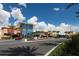 Retail shops in a modern shopping center with palm trees and well-maintained landscaping under a blue sky at 6612 Saint James Xing, University Park, FL 34201