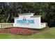 University Park Country Club sign with lush landscaping and a bright blue sky at 6612 Saint James Xing, University Park, FL 34201