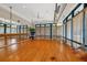 Bright studio with hardwood floors, mirrored wall, ballet barre, and large windows for fitness activities at 6612 Saint James Xing, University Park, FL 34201