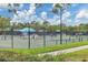 Active tennis courts showcase players enjoying a match amidst lush greenery in a vibrant setting at 6612 Saint James Xing, University Park, FL 34201