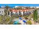 Aerial view of the condo complex, showcasing the pool, lush landscaping, and red tile roofs at 6790 Sarasea Cir # 6790, Sarasota, FL 34242