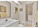 Bright bathroom with elegant vanity, decorative framed mirror and walk-in shower at 6790 Sarasea Cir # 6790, Sarasota, FL 34242