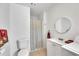 Bathroom featuring round mirror, sink, and walk-in shower with washer and dryer at 6790 Sarasea Cir # 6790, Sarasota, FL 34242