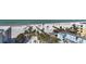 Aerial shot of sandy beach with palm trees, boardwalks, and building rooftops at 6790 Sarasea Cir # 6790, Sarasota, FL 34242