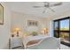 Comfortable bedroom with stylish ceiling fan, balcony and white wicker furniture at 6790 Sarasea Cir # 6790, Sarasota, FL 34242