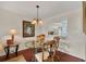 Charming dining room featuring a glass table, decorative lighting, and an open view to the kitchen at 6790 Sarasea Cir # 6790, Sarasota, FL 34242