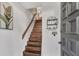 A white-walled entry with a wooden staircase and a coat rack, as well as an ornate door at 6790 Sarasea Cir # 6790, Sarasota, FL 34242