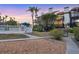 A townhome complex featuring a pool, white picket fences, decks, landscaping, and tropical palm trees at 6790 Sarasea Cir # 6790, Sarasota, FL 34242