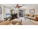 Bright living room with a mirrored fireplace, ceiling fan, and sliding glass doors to the outside patio at 6790 Sarasea Cir # 6790, Sarasota, FL 34242