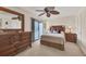 Comfortable bedroom with wood furniture, a large mirror, and access to a private balcony at 6790 Sarasea Cir # 6790, Sarasota, FL 34242