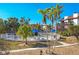 Community pool area with white fence, blue umbrellas, and palm trees, providing a relaxing atmosphere at 6790 Sarasea Cir # 6790, Sarasota, FL 34242