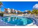 Community pool featuring blue tile trim and comfortable lounge seating for residents to enjoy at 6790 Sarasea Cir # 6790, Sarasota, FL 34242