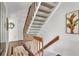 Carpeted staircase with wooden railing leading to the upper level of the home at 6790 Sarasea Cir # 6790, Sarasota, FL 34242
