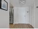 Clean entryway with white walls, modern light fixture, and a stainless steel refrigerator peeking into view at 101 S Gulfstream Ave # 7B, Sarasota, FL 34236