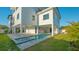 Modern home featuring a beautiful in-ground pool, spa, covered patio, and lush landscaping at 1210 Gulf Blvd, Englewood, FL 34223