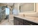 This stunning bathroom features elegant fixtures, a marble countertop, and a large glass shower at 1210 Gulf Blvd, Englewood, FL 34223