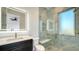 This bathroom features a glass shower with marble-like tiles and updated fixtures at 1210 Gulf Blvd, Englewood, FL 34223