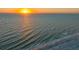 The ocean waves roll in with a view of the beach at sunset at 1210 Gulf Blvd, Englewood, FL 34223