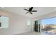 Bright bedroom with a ceiling fan and glass sliding doors opening to a large balcony at 1210 Gulf Blvd, Englewood, FL 34223