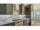 Elegant kitchen featuring modern appliances, marble countertops, and stylish dark wood cabinetry at 1210 Gulf Blvd, Englewood, FL 34223