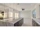 Spacious kitchen island with marble countertop and storage, illuminated by pendant lighting at 1210 Gulf Blvd, Englewood, FL 34223