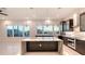 Open kitchen featuring a large island with marble countertop and ocean views through expansive windows at 1210 Gulf Blvd, Englewood, FL 34223
