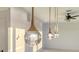 Close-up of modern jellyfish pendant lights illuminating the space at 1210 Gulf Blvd, Englewood, FL 34223