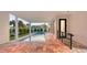 Inviting covered patio with a sparkling in-ground pool and spa surrounded by tropical landscaping at 1210 Gulf Blvd, Englewood, FL 34223