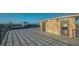 Spacious roof deck with gray tiled floors, dark railing, and stone accent wall offers beautiful panoramic views at 1210 Gulf Blvd, Englewood, FL 34223