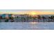 Spacious rooftop deck with a view of colorful beachfront homes against a beautiful sunset backdrop with black railings at 1210 Gulf Blvd, Englewood, FL 34223