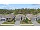 Aerial view of homes featuring well-manicured landscaping, gray roofing, and paved driveways at 2081 Gardenia Ave, Port Charlotte, FL 33953