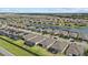 Expansive aerial view of a well-planned community with lake views, solar panels, and landscaped lawns at 2081 Gardenia Ave, Port Charlotte, FL 33953